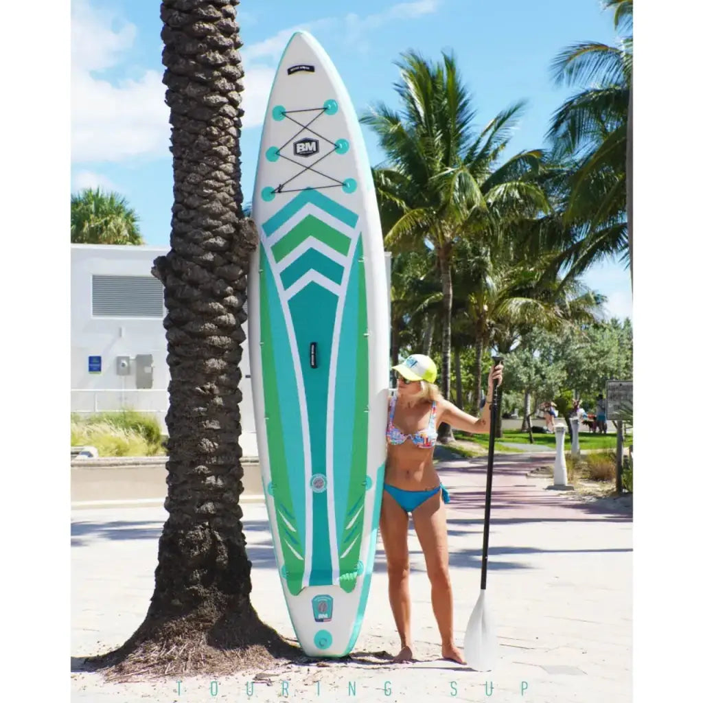 Woman in bikini holding inflatable paddle board: iSUP DUAL AIR for ultimate adventure